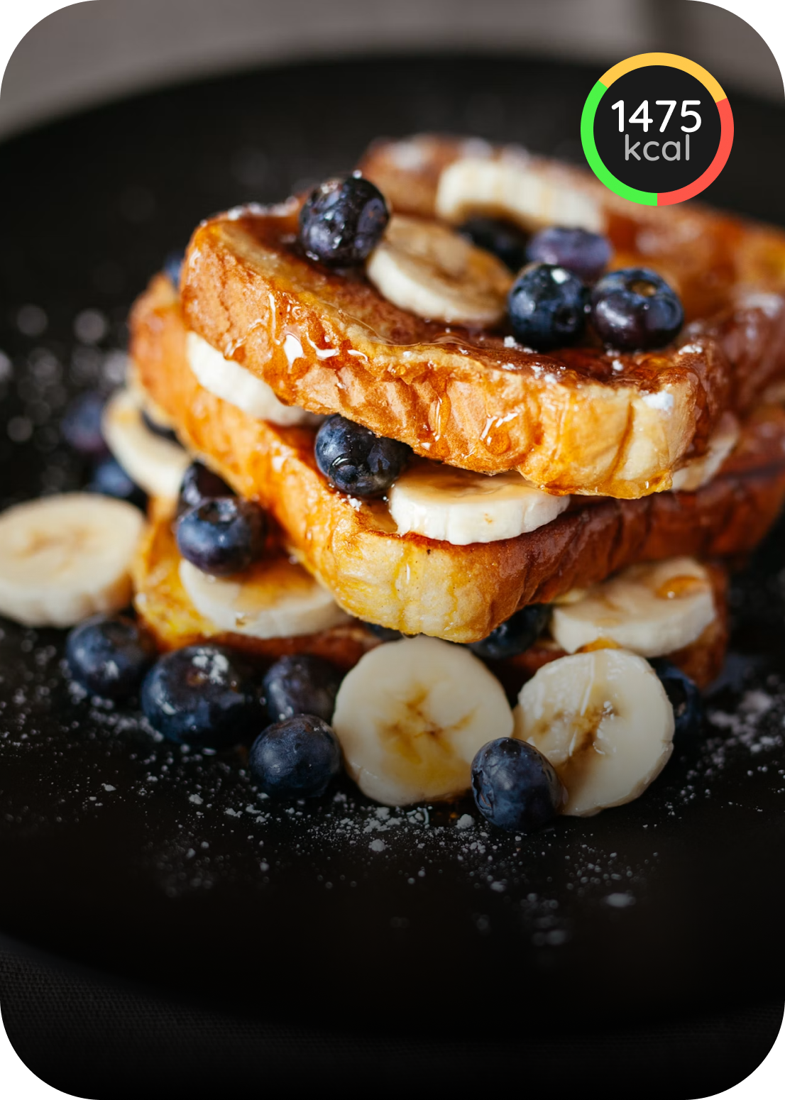 French toast topped with blueberries, banana, and syrup