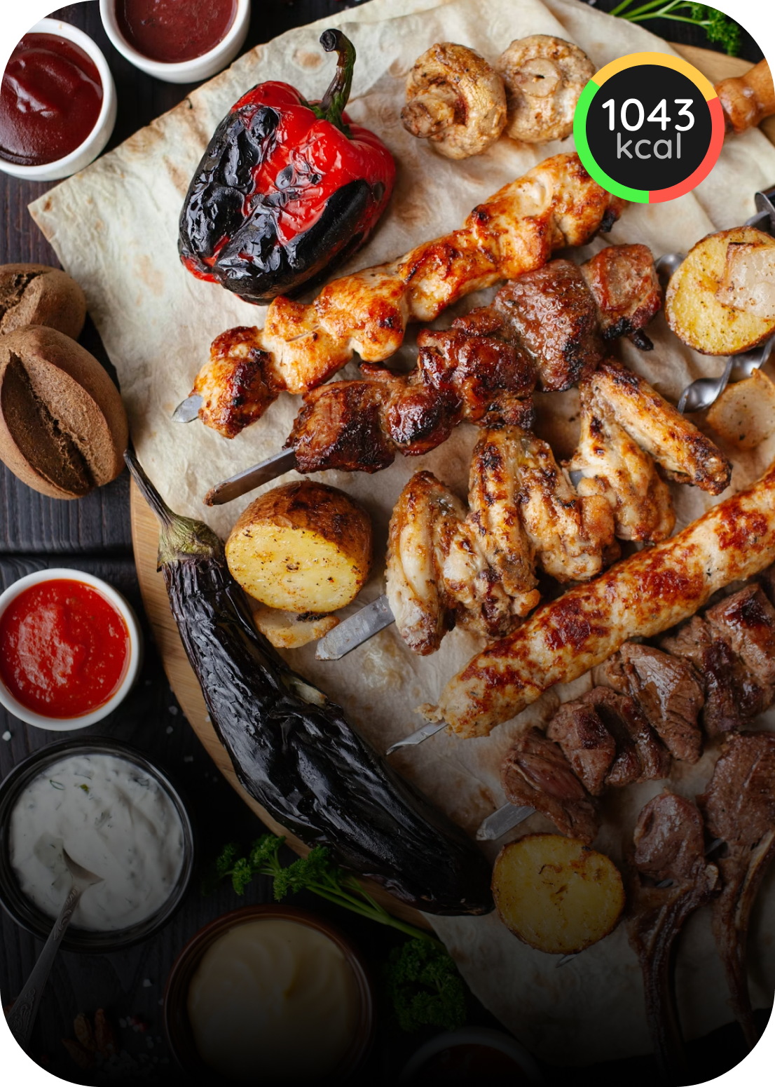 Grilled skewers, vegetables, and potatoes served with sauces