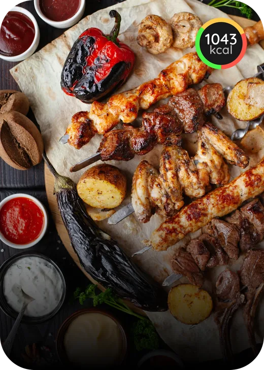 Grilled skewers, vegetables, and potatoes served with sauces